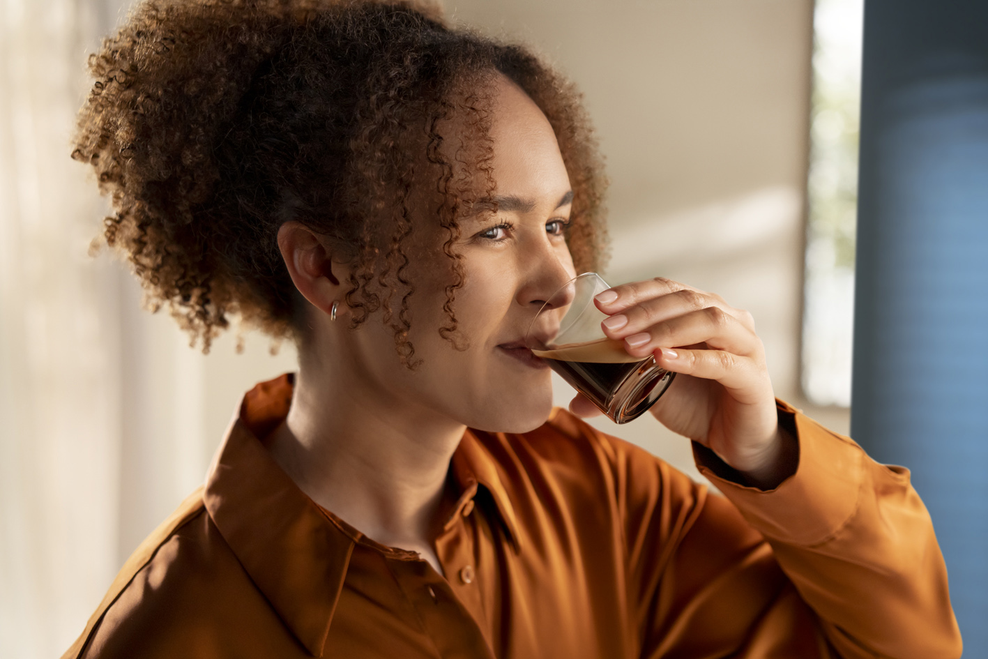 a young lady drinking coffee